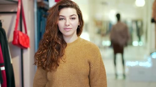 Young Woman Holds Shopping Bags in Boutique
