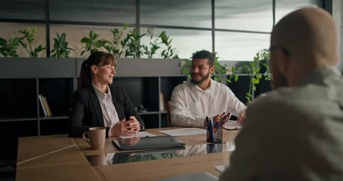 Business Meeting at Conference Table in Modern Office