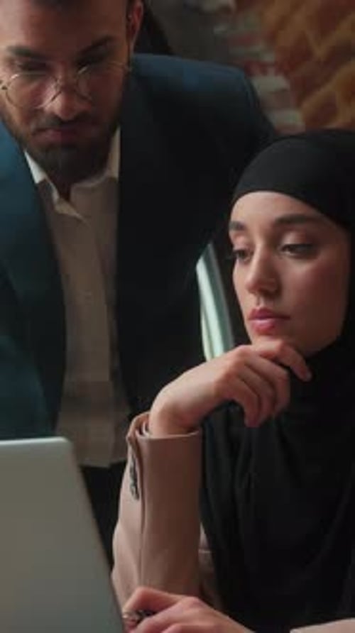 Two Professionals Business Team Cooperation in Office with Laptop Male Businessman Teaching Female