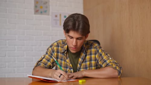 Man College Student Studying at Home Pov Sitting at Desk Listening Watching Lesson Online on