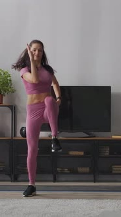 Brunette Woman Exercising Cardio in Pink Workout Clothes
