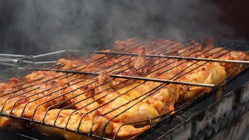 Delicious Chicken Frying on Barbecue Grill Grate Outdoor Seasoning Falling on Fresh Grilled Chicken