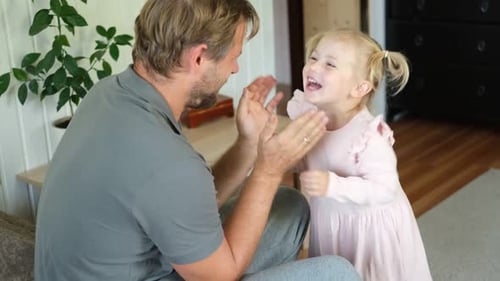 Father and Daughter Playful Interaction at Home