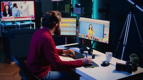 Young Adult Man Editing Video at Desk