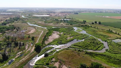 Aerial drone video showcasing river canals on a serene rural countryside landscape, with expansive p