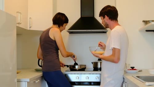 Couple Prepares Food Together in Sunny Kitchen