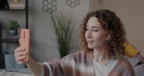 Woman with Curls Records Video on Phone