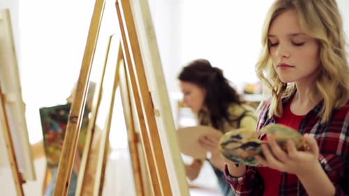 Art School, Creativity And People Concept - Group Of Students With Easels And Palettes Painting S...