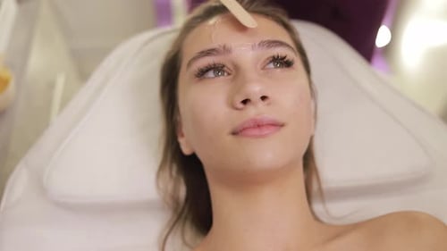 A Young Woman Enjoys a Rejuvenating Facial in a Tranquil Spa Radiating Relaxation and Peace