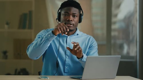 Webcam View African American Businessman Man Internet Teacher Coach in Headphones with Laptop Talk