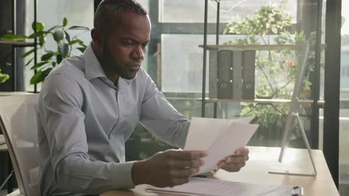 Professional Man Feeling Stressed at Office Desk