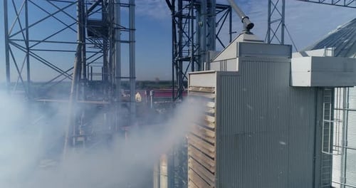 Smoke from industrial plant. Modern grain elevators from the air.
