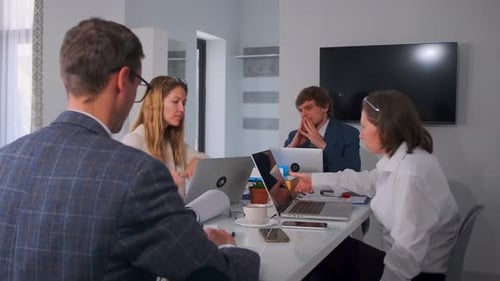 Business Team Meeting Around Table Discussing Documents