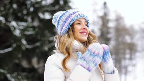Smiling Woman in Winter Hat Outside in Snowy Forest