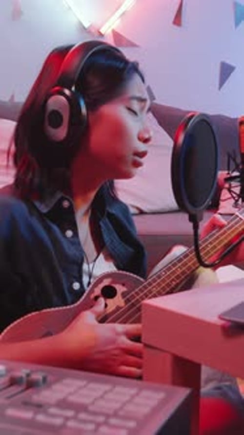 Asian Girl Recording Song with Ukulele in Home Music Studio