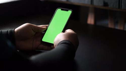 Close up and slide movement of a man facetime with a smartphone. Chroma key green screen on the smar