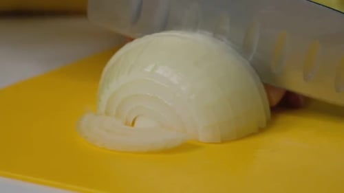 Close Up of an Onion Being Sliced