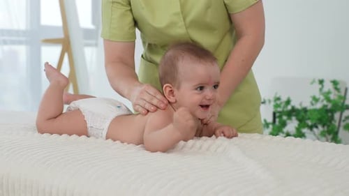 Infant Receiving Gentle Massage on Treatment Table