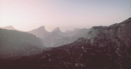 Aerial Flyover Through Rugged Mountain Landscape