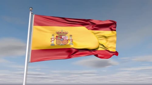 Spain Flag Waving in Wind Against Blue Sky