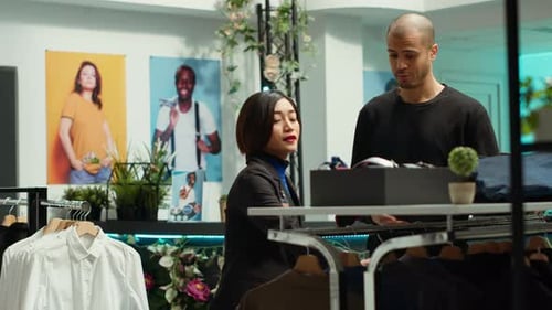 Asian Store Associate Helps a Young Man Client with Style Advice