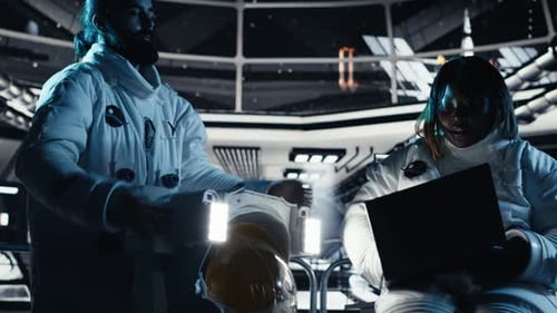 Astronaut Reviewing Onboard Analytics on Laptop Before Stepping Out of Station