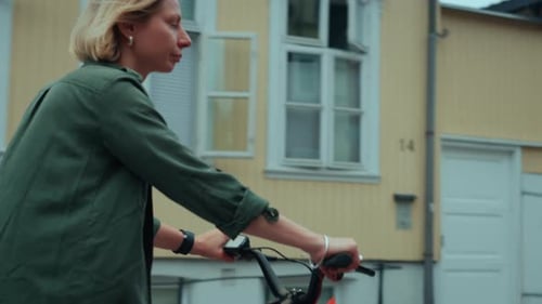 Cute Young Woman Ride City Ebike on Summer Street