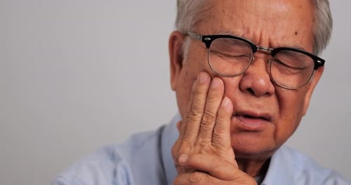 Senior Adult with Toothache in Close Up Shot