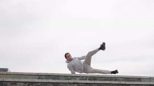 Parkour Athlete Performing Acrobatics on Building Ledge
