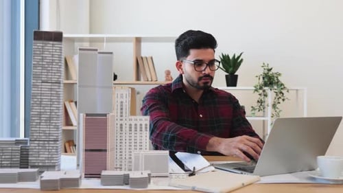 Indian Architect Designing Urban Cityscape in Modern Office Space