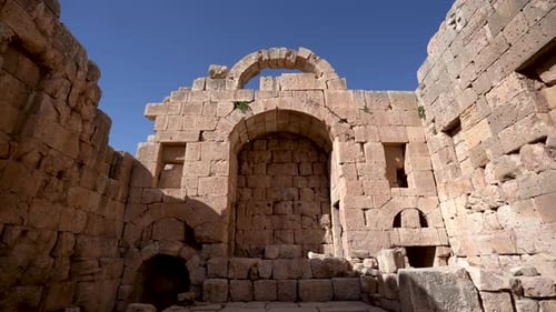 Still Shot of Ancient Stone Church Ruins with Grass Growing Between Spaces of Wall in Roman Ruins in