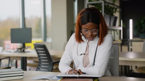 Focused African American Medical Student Studying in Library