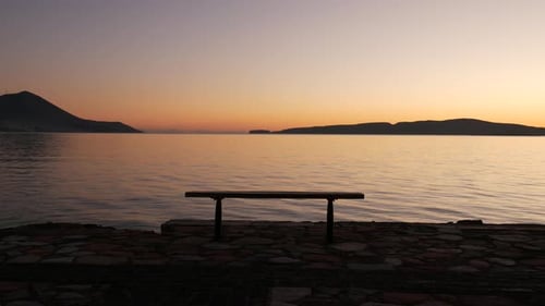 Epic shot of an empty bench with a golden sunset view. Extremely relaxing atmosphere. Magic colors a
