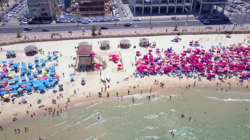 Mediterranean beach during summer with people in the water