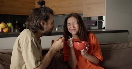 Affectionate Couple Sharing a Meal Together at Home