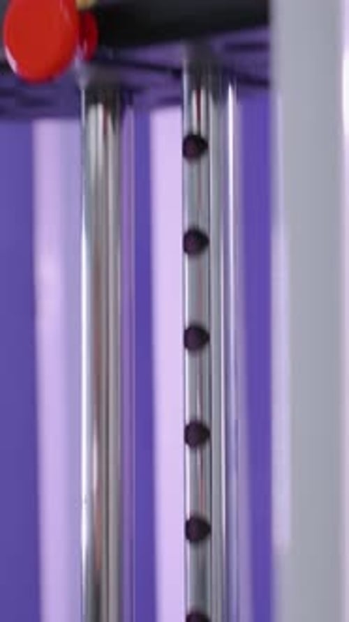 Close Up of Weight Being Dragged Down with Purple Background in Gym