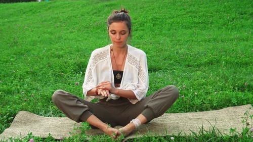 Young Woman Doing Yoga Outside
