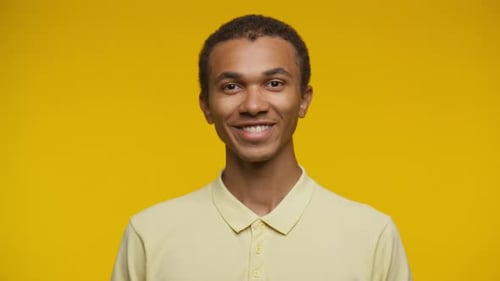 Smiling Young Man on Yellow Background