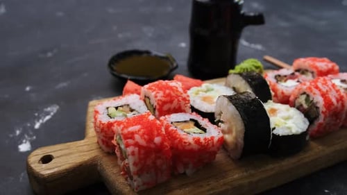 Assortment of Vibrant Sushi Rolls on Wooden Board