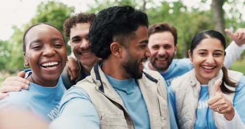 Smiling Volunteers Take Selfie in Park