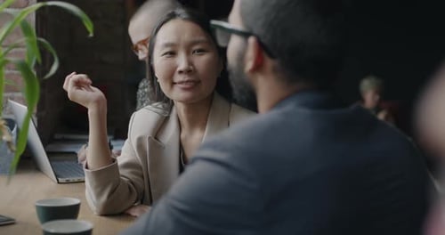 Woman and Man Talk in Modern Office