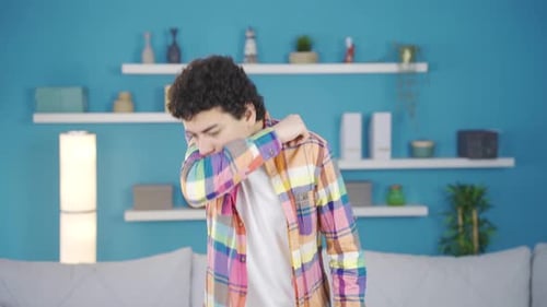 The sick boy is coughing and having shortness of breath.