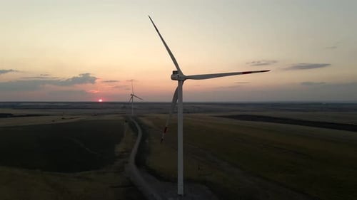 Windmills Generating Electric Power at Sunset in a Scenic Windmill Park Showcasing Green Energy