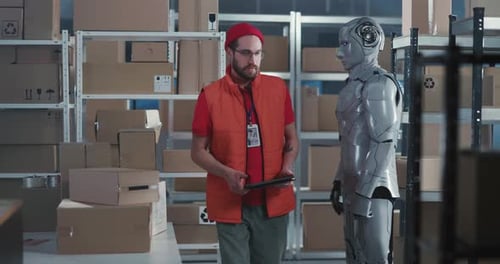 Warehouse Worker Discussing Boxes with Humanoid Robot