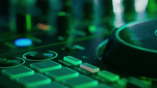 Closeup of DJ Mixing Board in Neon Club Lights