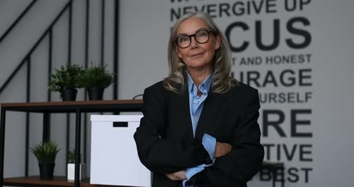 Confident Mature Woman Posing in Modern Office Setting