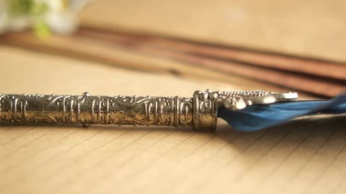 Ornate Pen Resting on Parchment Paper