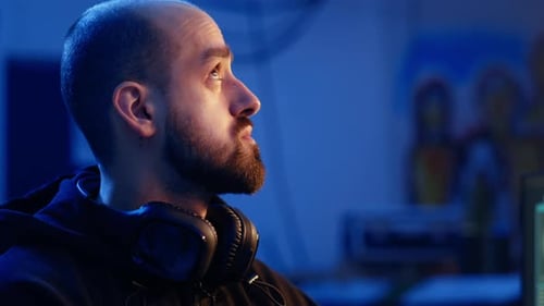 Hacker Looking Over Shoulder and Feeling Anxious After Stealing Data