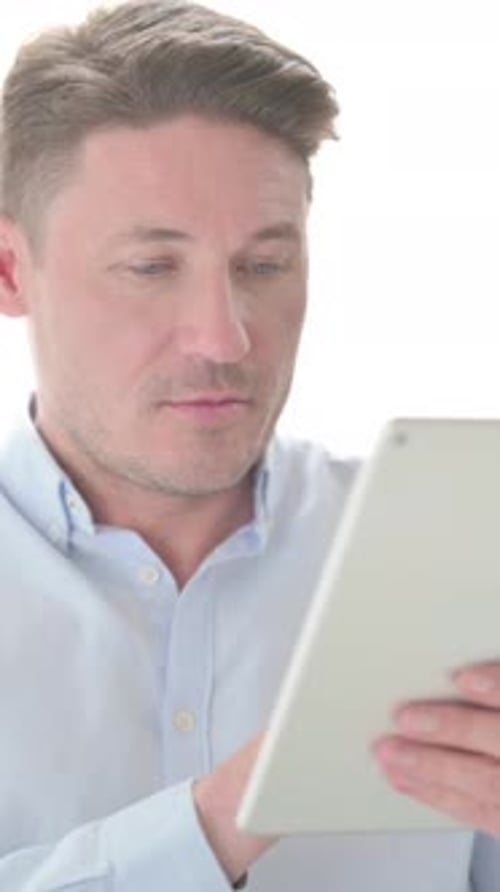 Portrait of Man using Tablet in Office, Vertical Video