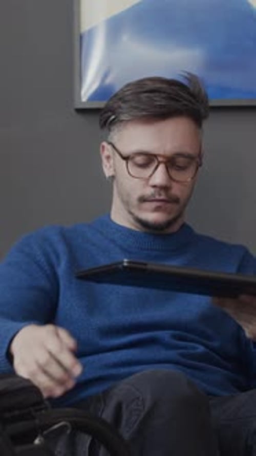 Wheelchaired Man Working on Laptop Computer in Office
